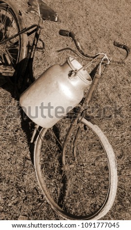 Similar – Image, Stock Photo Very old milk churns made of sheet metal with handle and lid. On one pot is the word “kitchen”.