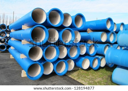 piles of concrete pipes for transporting water and sewerage