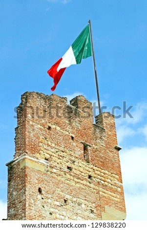 Italian flag flying high above an ancient tower