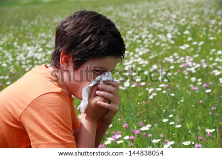 allergic child to pollen and flowers with a handkerchief while sneeze in the middle of the Minesweeper