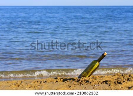 secret message in glass bottle on the seashore