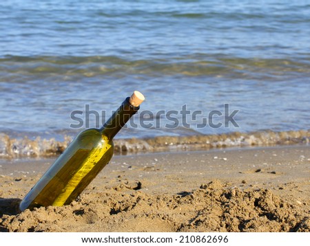 secret message in glass bottle on the shore of the ocean
