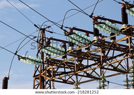great insulators and electric cables in a large power plant with tall pylons of high voltage cables