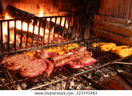 beef and pork cooked on the grill in the glowing embers of the fireplace
