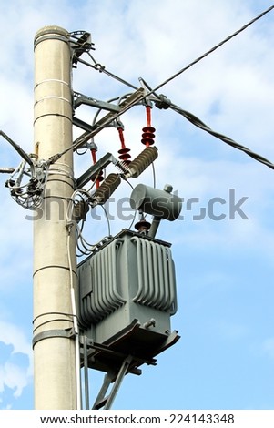 big electricity transformer with cables on a pylon