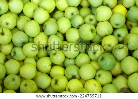 background of green apples on sale at the local market