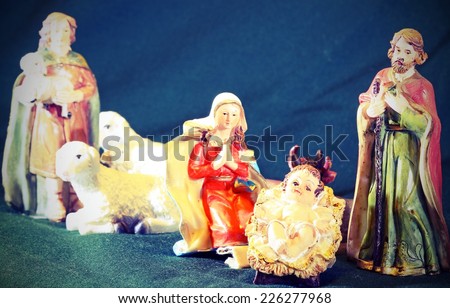 Mary and Joseph with the child Jesus in the manger with a shepherd and sheep