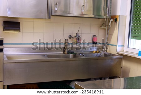 Steel sink and the Workbench in an industrial kitchen in the school canteen