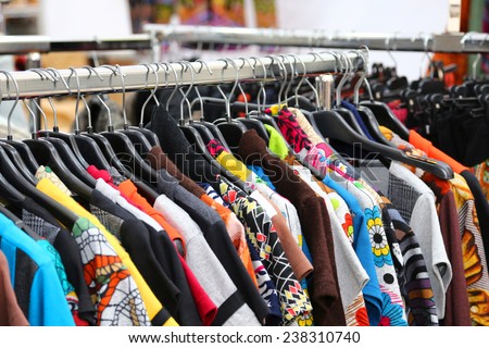 set of vintage clothes of many colors for sale at flea market