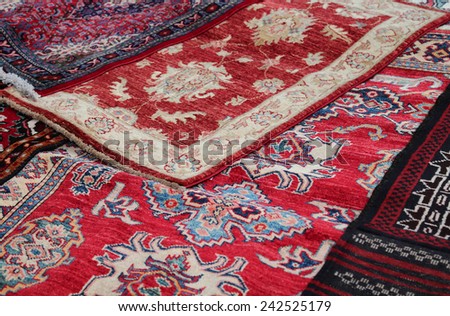 Red Asian rugs for sale in the shop of fabrics and textiles