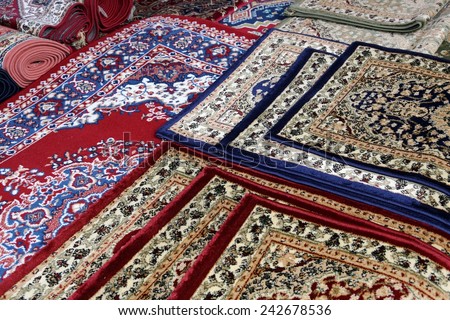 many colourful oriental carpets for sale in the shop of rugs