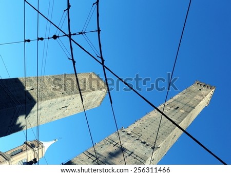 ancient tower called DEGLI ASINELLI in Bologna Center in Italy with tram wires