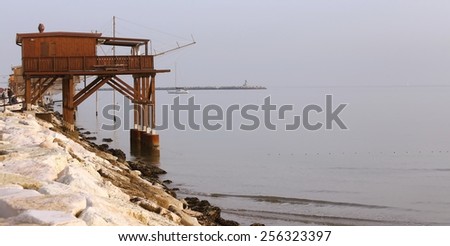 large wooden stilt house on the seashore