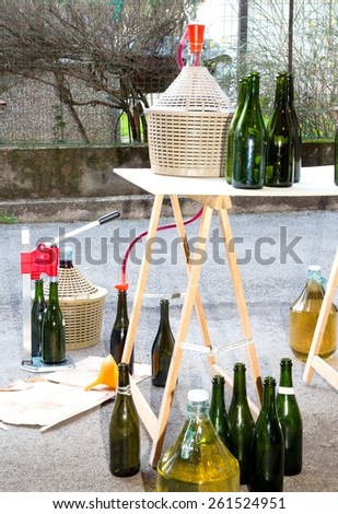pour the wine in the backyard with the Carboy and glass bottles