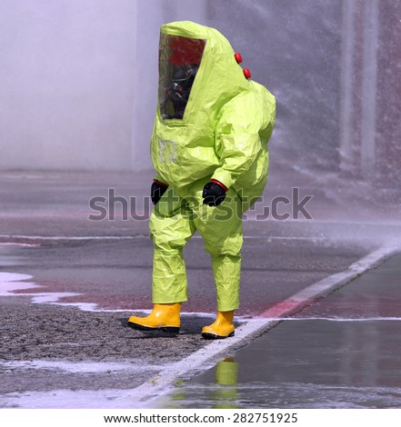 man with yellow protective suit against biological risk