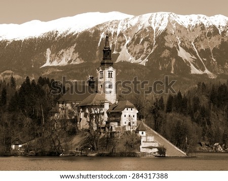 Church on the island of Lake BLED in SLOVENIA Europe and the snowy mountains