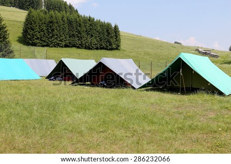 tents of a campsite of the boy scouts in the mountains in summer
