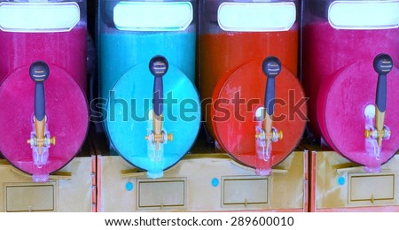 italian shave ice machine with many colored flavors and iced at the bar