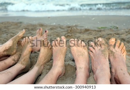 ten feet of a family barefoot by the sea on the beach