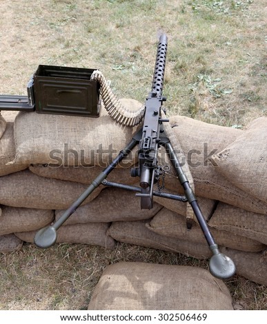 machine gun with ammunitions over the sandbags in the trench war
