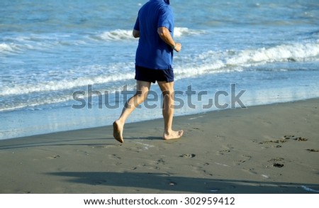 mature athlete runs on the Sea Beach to keep fit