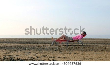 man lying on a bed by the beach by the sea