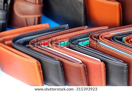 handcrafted leather wallets for sale in a stand of the European market