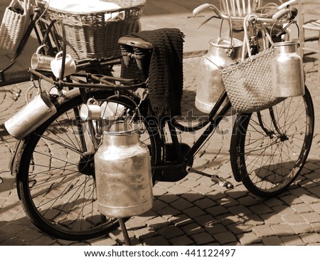 Similar – Image, Stock Photo Very old milk churns made of sheet metal with handle and lid. On one pot is the word “kitchen”.