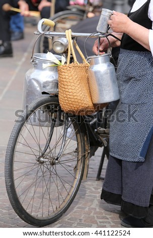 Similar – Image, Stock Photo Very old milk churns made of sheet metal with handle and lid. On one pot is the word “kitchen”.