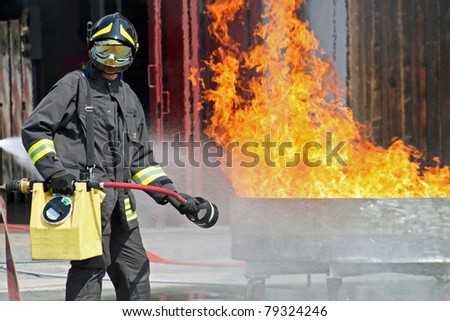 Firefighters extinguish a fire during training