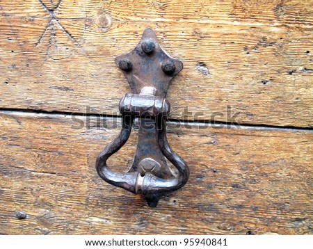 ancient wrought iron door knockers on medieval door wood