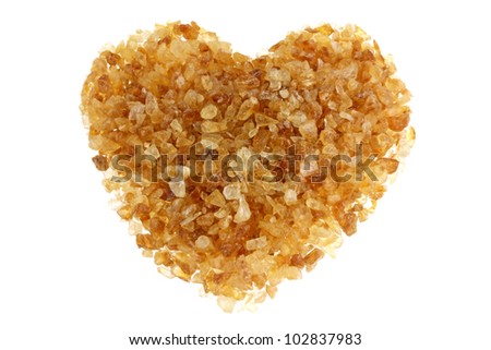 Brown sugar with a shape of heart, isolated on a white background