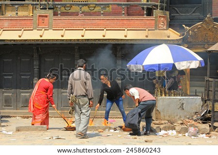 KATHMANDU, NEPAL - APRIL 2014 : Nepalese worshipers are giving religious offerings to Akash Bhairav, Hindu deity, at Akash Bhairav Temple in Kathmandu, Nepal on 12 April 2014.