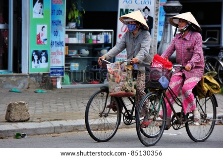 HANOI, VIETNAM - SEPTEMBER 17: Unidentified womans rides bicycle along Ma May street in Hanoi, Vietnam on September 17, 2010. Transportation Police Bureau estimated some 20 million bicycles in Vietnam