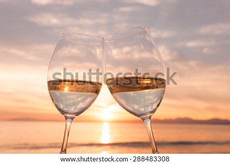 Wine glass and dusk of beach