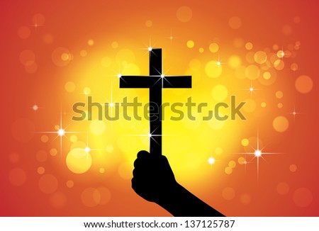 Person holding holy cross,christian religious symbol,in hand(fist) - concept of a devout faithful christian worshiping Jesus Christ with yellow and orange background of stars and circles