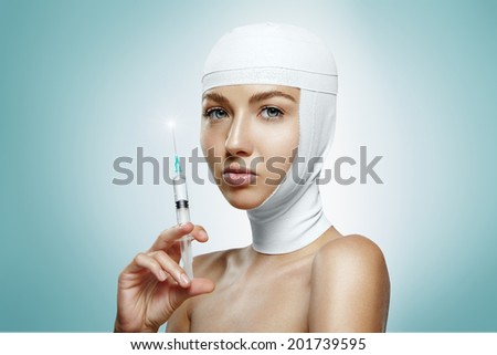 woman holding the injection with bandaged head