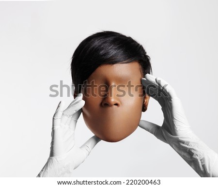 doctor holding woman blank face mask without eyes and lips