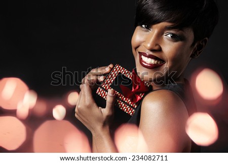 beauty woman with a gift, evening makeup, flair on a background