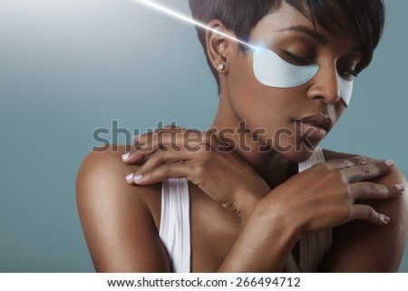 woman with a patches above her eyes and a rey of light