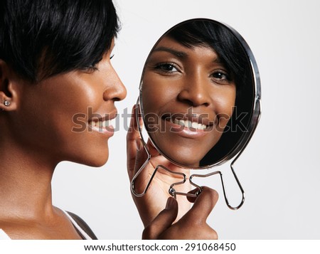 beauty black woman watching in mirror