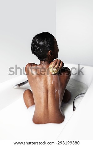 black woman with a short haircut have a milk bath