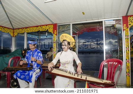 Local music shows on the dragon boat during travel in the Perfume river : a famous program of the middle Vietnam tourism. Hue, Vietnam- August, 18, 2013.
