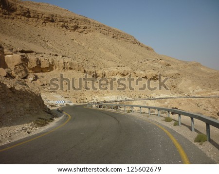 Desert road/Road through the desert and sandy hills Road through the desert and sandy hills