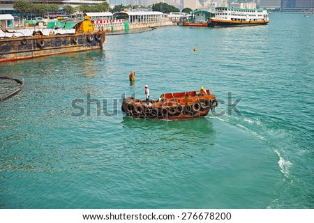 HONG KONG-SEPTEMBER, 2012:  Workers in the port of Hong Kong on the barge. Hong Kong Special Administrative Region of the People\'s Republic of China