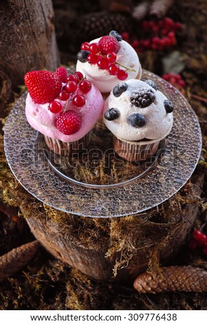 Forest Candy bar, decorated with fresh berries with delicious cakes. Wedding decor decorations for weddings forest. Three cakes decorated with moss on a stump