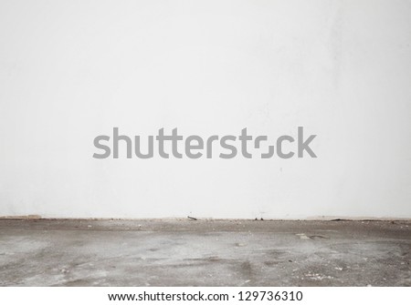 White construction stucco wall and cement floor