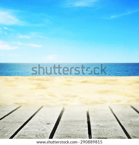 Wooden path near summer beach in sand on sunny day near the sea