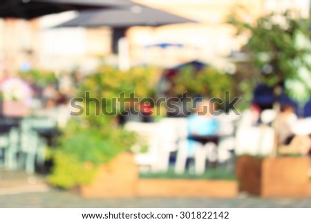 People in restaurant outside, blurred background