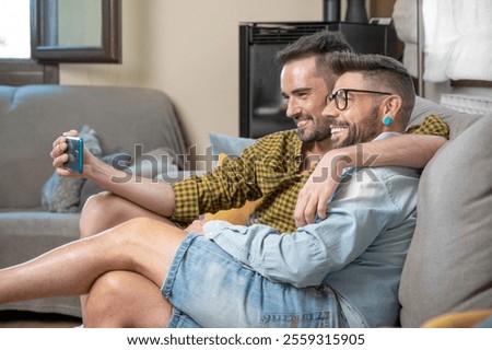 Similar – Image, Stock Photo Cheerful gay couple taking selfie on smartphone
